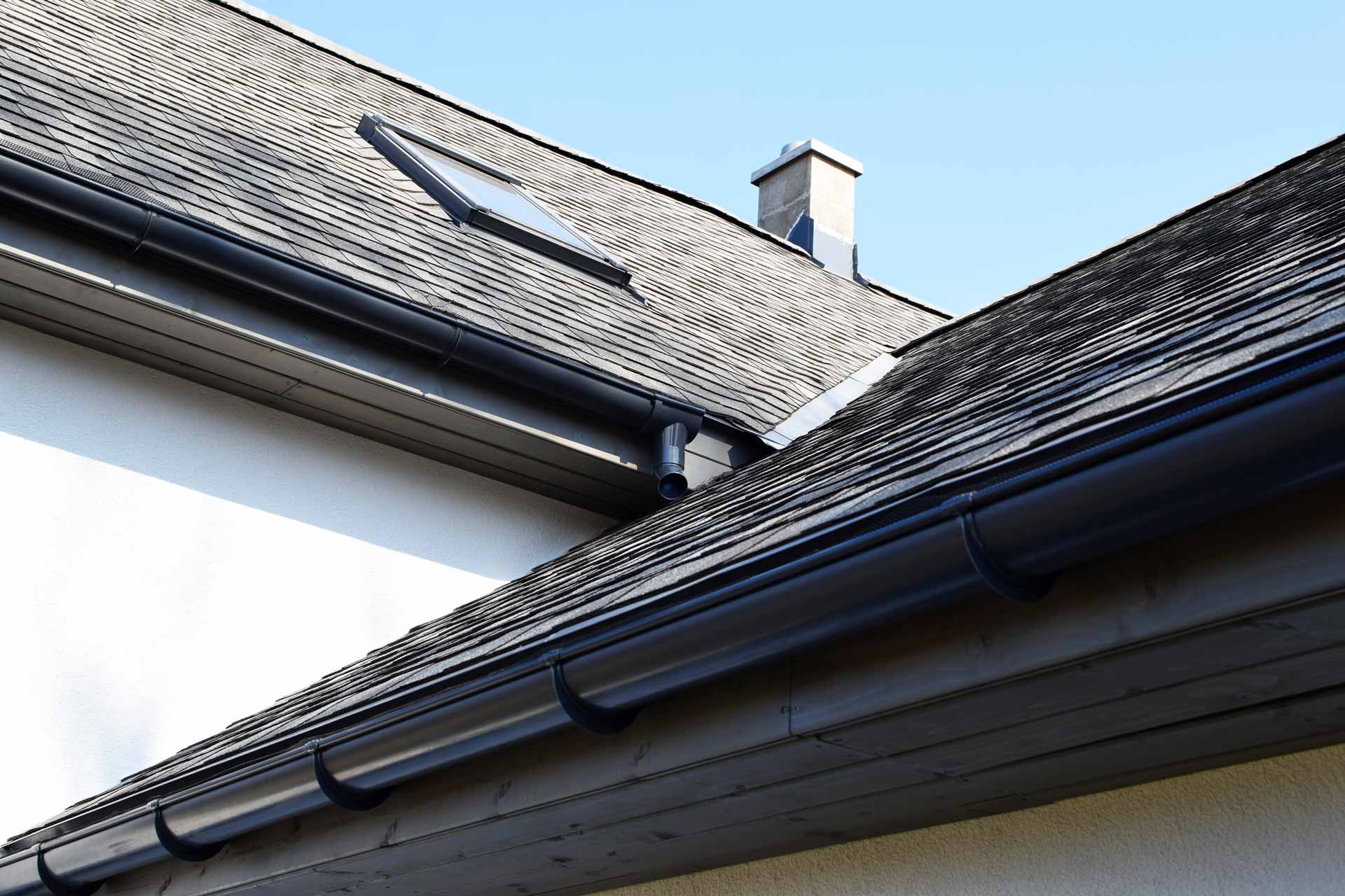 Asphalt roof with new gutters and a skylight
