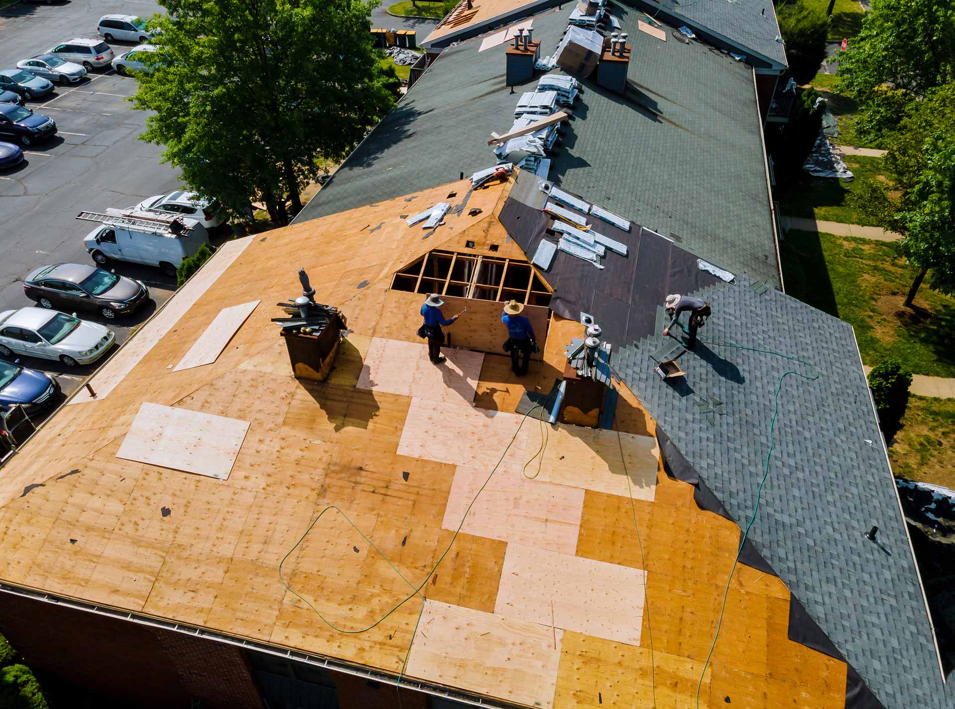 Roofing crew at work on asphalt shingle roof